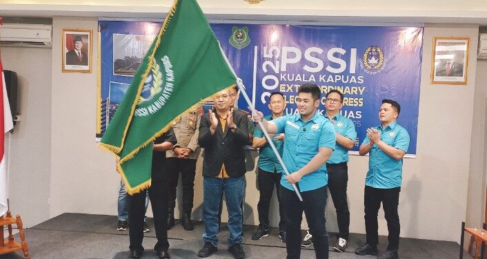 Ketua Askab PSSI Kapuas terpilih Ahensa Mullah Muhammad mengibarkan bendera petaka PSSI.
